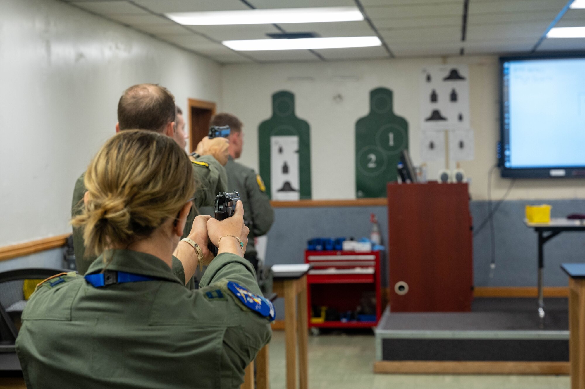 U.S. Air Force Capt. Miki Mullen, 309th Fighter Squadron student pilot, practices proper aiming with an M9 service pistol during a qualification course, Oct. 27, 2022, at Luke Air Force Base, Arizona.