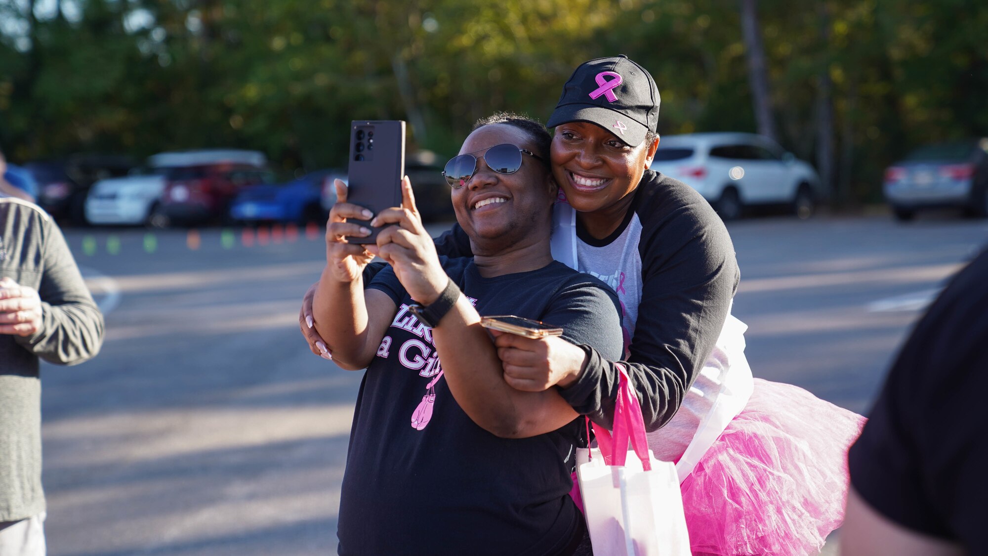 U.S. Air Force Tech. Sgt. LeVonya Davis, 81st Medical Support Squadron medical information systems section chief, takes a selfie with a friend at the Mississippi Gulf Coast Strides Against Breast Cancer 5K in held at the AJ Holloway Sports Complex in Biloxi, Mississippi, Oct. 15, 2022.
