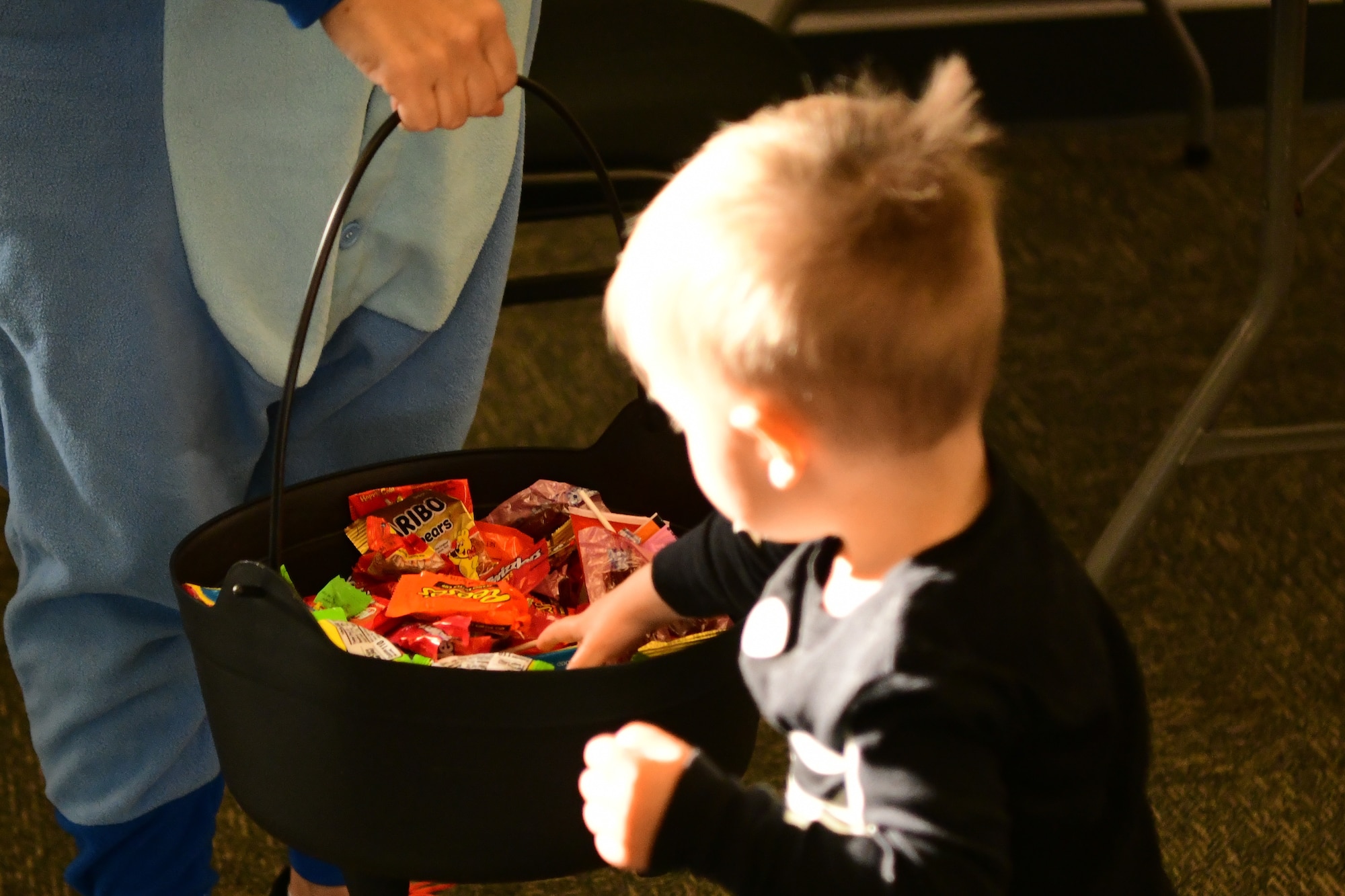 A child reaches for candy at the Community Activity Center on Beale Air Force Base, Calif., on Oct. 28, 2022.