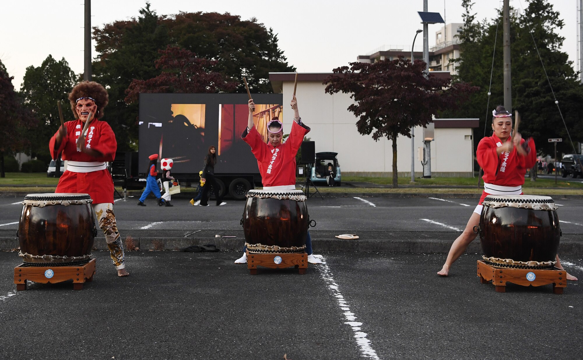 Lashae Snider, left, Takako Watanabe, center, and Asami Iwata, right, Samurai Taiko Drum Team members, perform during a Trunk or Treat Halloween event at Yokota Air Base, Japan, Oct. 28, 2022. Members of the base community were able to trick or treat and enjoy Halloween festivities during the event. Celebrating holidays like Halloween is an opportunity for members of Yokota Air Base to enjoy some time with family and friends. (U.S. Air Force photo by Tech. Sgt. Christopher Hubenthal)