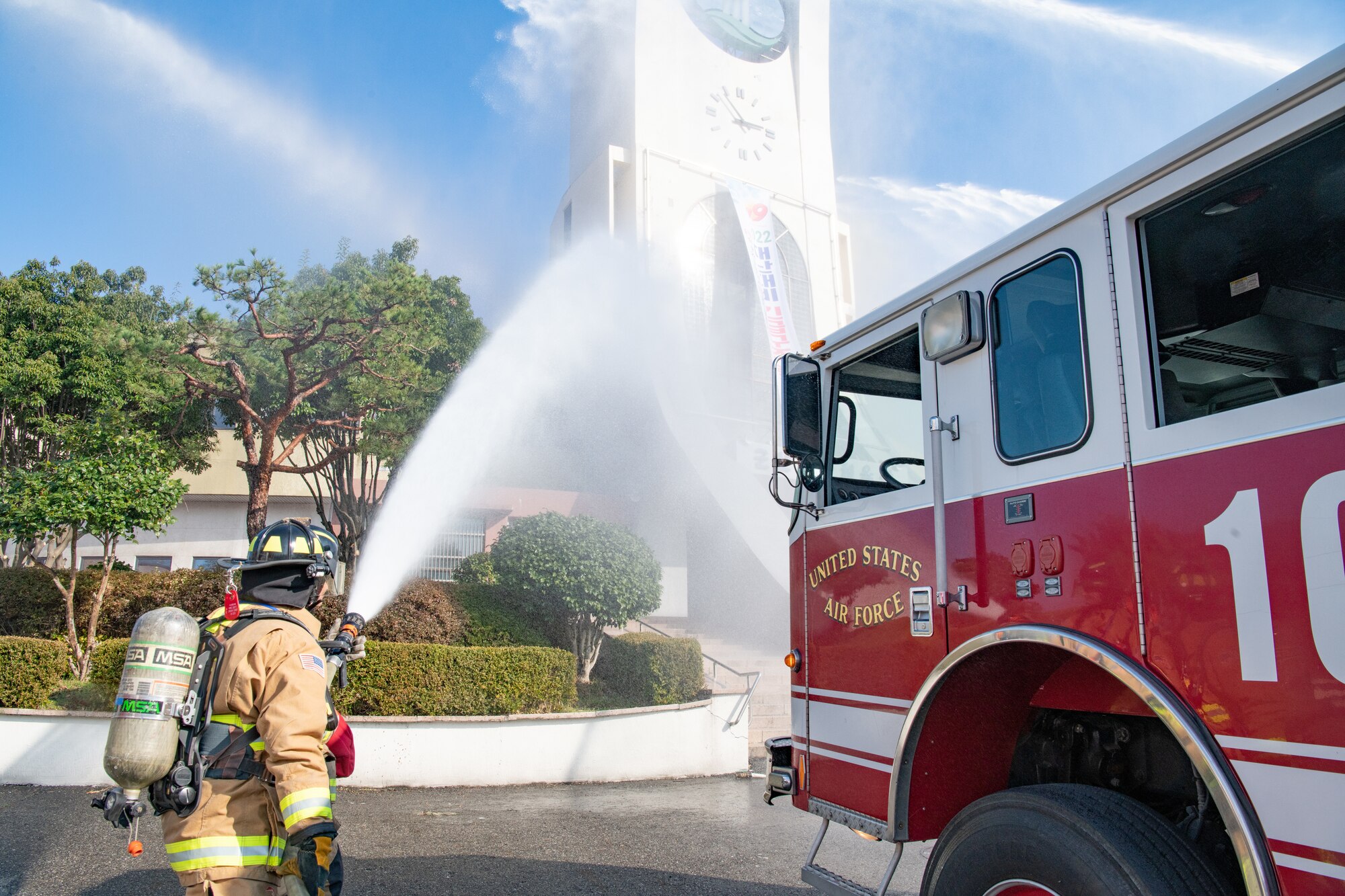 Airman Jacob McLaughlin, 8th Civil Engineer Squadron firefighter, sprays water at the Wolmyung Stadium during a local training event, at Gunsan City, Republic of Korea, Oct. 28, 2022. The training event allowed the Wolf Pack to showcase their firefighting capabilities to the local populace, reaffirming their commitment to the Republic of Korea people. (U.S. Air Force photo by Staff Sgt. Sadie Colbert)