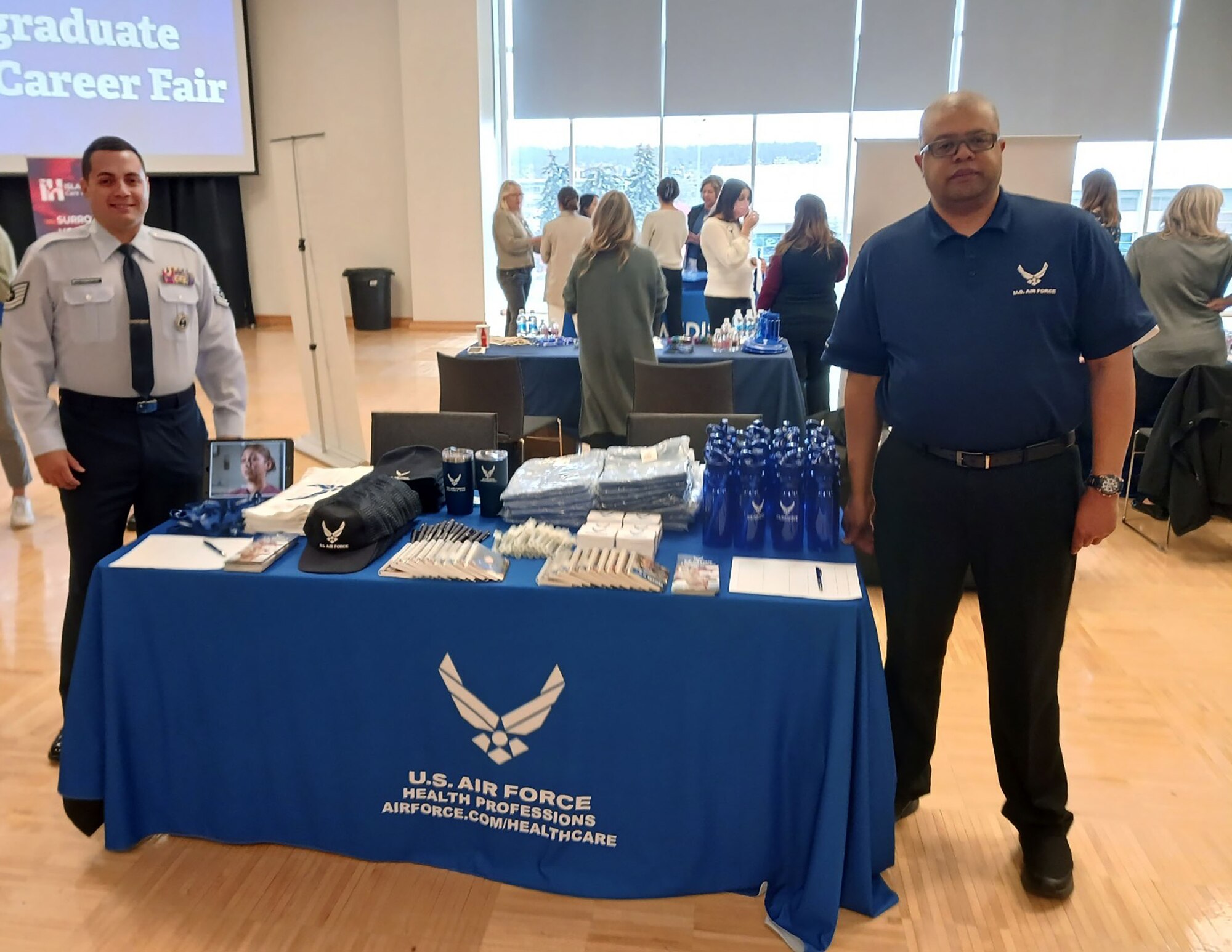 Air Force recruiting assistant and recruiter man a booth at a career fair in Washington