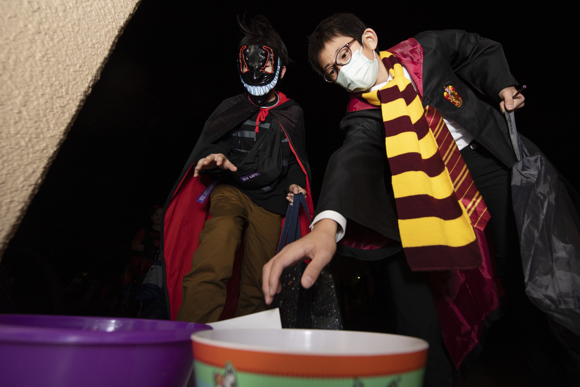 Riku Yamauchi, left, and Yuki Morizono, trick-or-treaters, get candy during trick-or-treating at Yokota Air Base, Japan, Oct. 29, 2022. This year, members of the base were able to sponsor up to ten visitors onto base for trick-or-treating. Celebrating holidays like Halloween is an opportunity for members of Yokota Air Base to enjoy some time with family and friends from the base and Japanese local community. (U.S. Air Force photo by Tech. Sgt. Christopher Hubenthal)