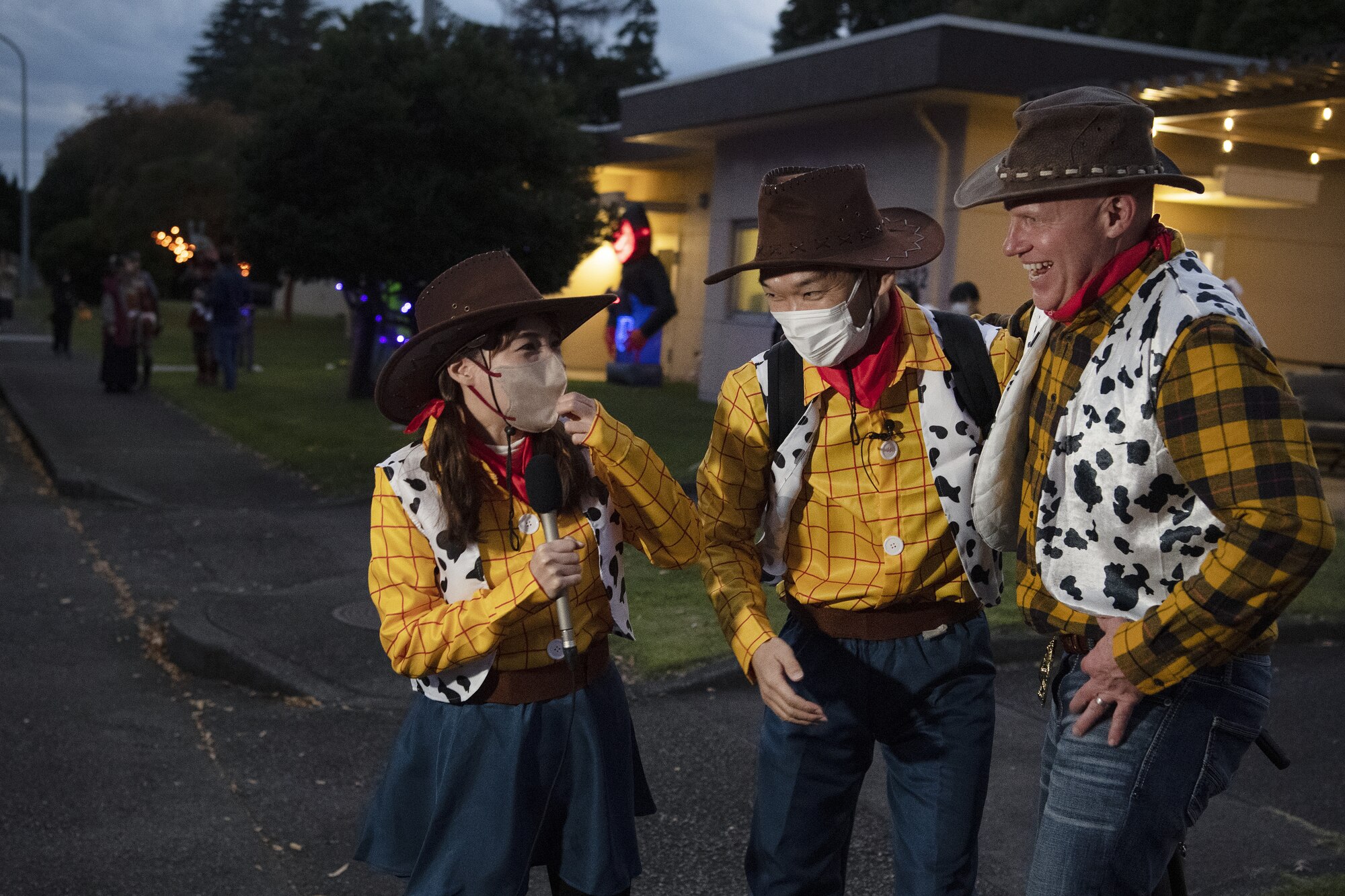 Col. Philip Dorsch, right, 374th Maintenance Group commander, and Yoshihiro Sato, center, and Miki Limura, left, Tama Cable reporters, admire each other’s costumes during trick-or-treating at Yokota Air Base, Japan, Oct. 29, 2022. This year, members of the base were able to sponsor up to ten visitors onto base for trick-or-treating. Activities like trick-or-treating help build mutual understanding of the distinctive cultures of the U.S. and Japan, deepen friendships, and further strengthen the critical relationship Yokota has with its surrounding communities. (U.S. Air Force photo by Tech. Sgt. Christopher Hubenthal)
