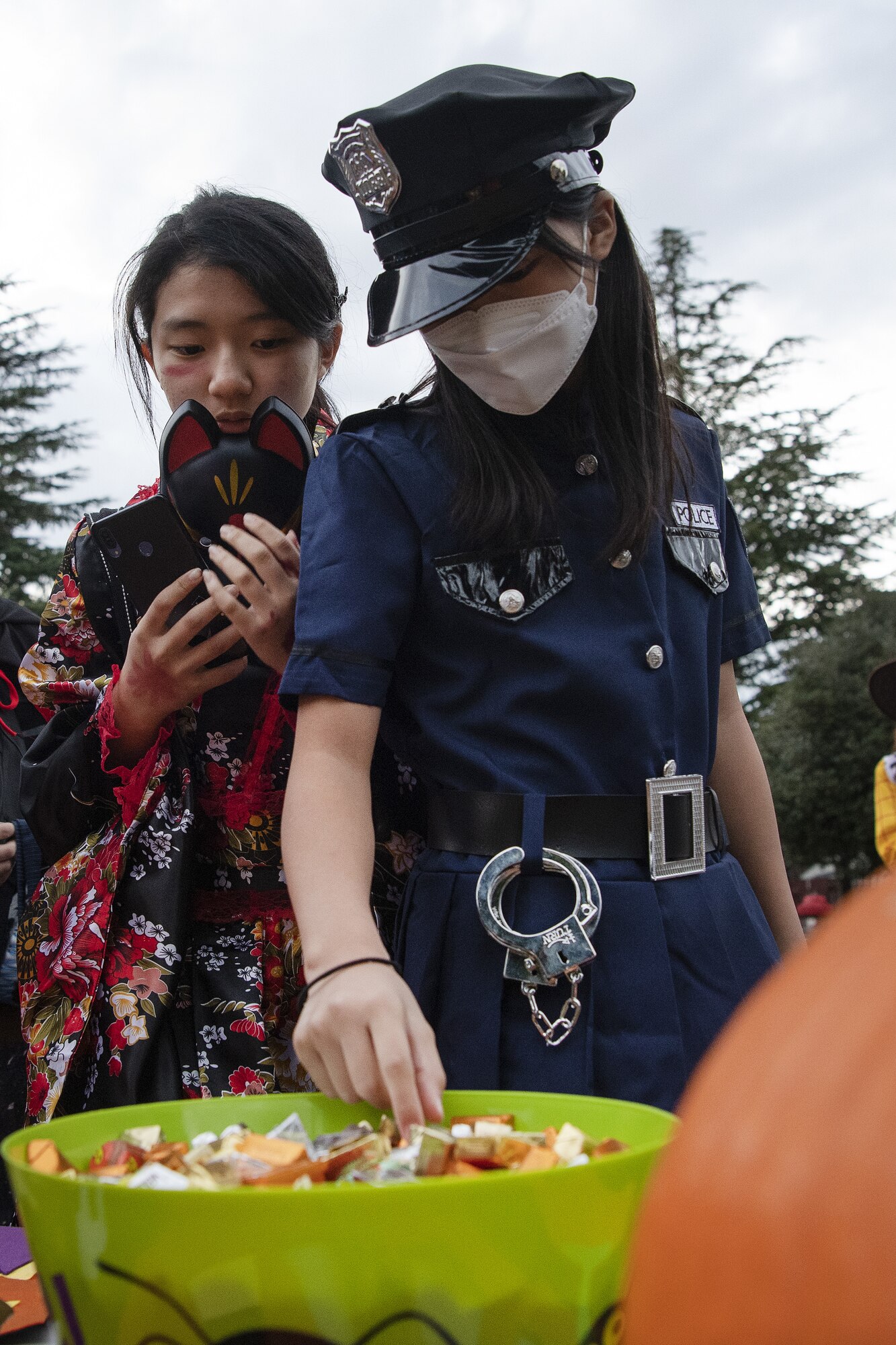 Rin Imai, left, and Kao Nishibe, trick-or-treater, get candy during trick-or-treating at Yokota Air Base, Japan, Oct. 29, 2022. This year, members of the base were able to sponsor up to ten visitors onto base for trick-or-treating. Celebrating holidays like Halloween is an opportunity for members of Yokota Air Base to enjoy some time with family and friends from the base and Japanese local community. (U.S. Air Force photo by Tech. Sgt. Christopher Hubenthal)