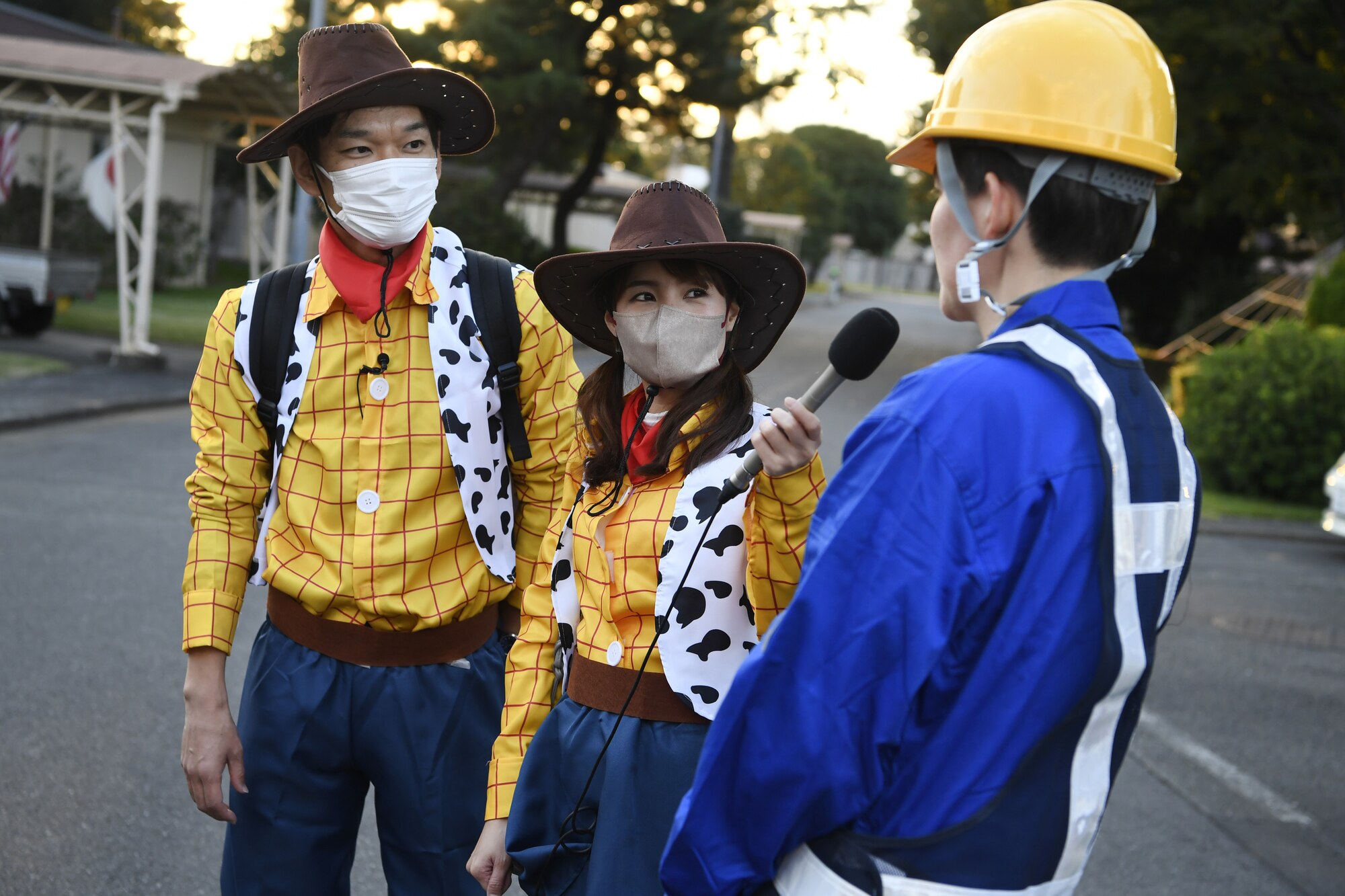 Yoshihiro Sato, left, and Miki Limura, center, Tama Cable reporters, interview Col. Julie Gaulin, 374th Airlift Wing vice commander, during trick-or-treating at Yokota Air Base, Japan, Oct. 29, 2022. This year, members of the base were able to sponsor up to ten visitors onto base for trick-or-treating. Activities like trick-or-treating help build mutual understanding of the distinctive cultures of the U.S. and Japan, deepen friendships, and further strengthen the critical relationship Yokota has with its surrounding communities. (U.S. Air Force photo by Tech. Sgt. Christopher Hubenthal)