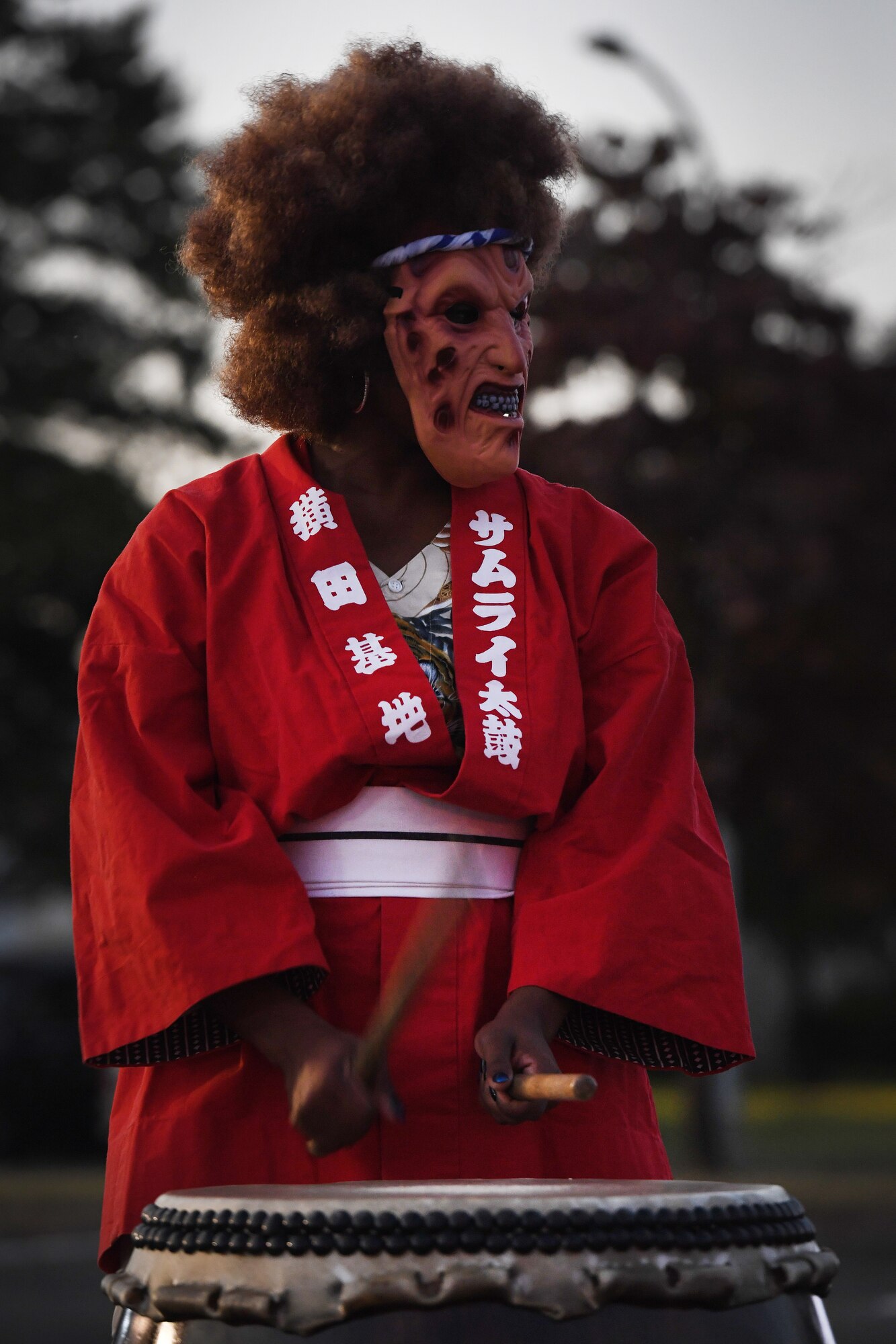 Lashae Snider, Samurai Taiko Drum Team member, performs during a Trunk or Treat Halloween event at Yokota Air Base, Japan, Oct. 28, 2022. Members of the base community were able to trick or treat and enjoy Halloween festivities during the event. Celebrating holidays like Halloween is an opportunity for members of Yokota Air Base to enjoy some time with family and friends. (U.S. Air Force photo by Tech. Sgt. Christopher Hubenthal)