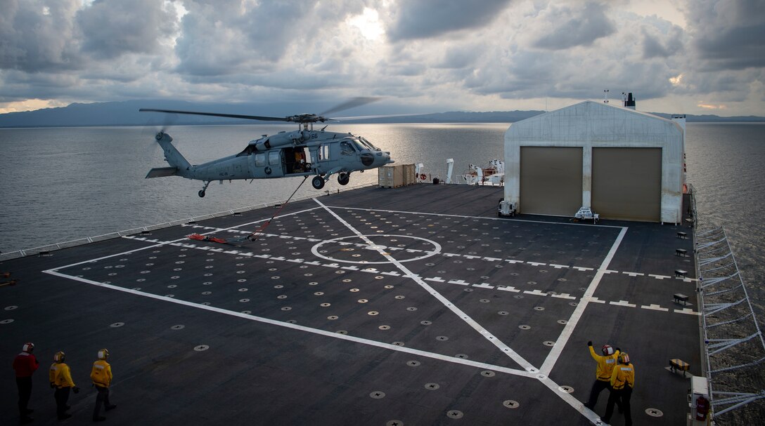 221026-N-MY642-1017

PUERTO BARRIOS, Guatemala (Oct. 26, 2022) An MH-60S Seahawk, assigned to the "Chargers" of Helicopter Sea Combat Squadron 26, carries cargo nets from the coast of Puerto Barrios after the hospital ship USNS Comfort's (T-AH 20) arrival, Oct. 26, 2022. Comfort is deployed to U.S. 4th Fleet in support of Continuing Promise 2022, a humanitarian assistance and goodwill mission conducting direct medical care, expeditionary veterinary care, and subject matter expert exchanges with five partner nations in the Caribbean, Central and South America. (U.S. Navy photo by Mass Communication Specialist 1st Class Donald R. White Jr.)