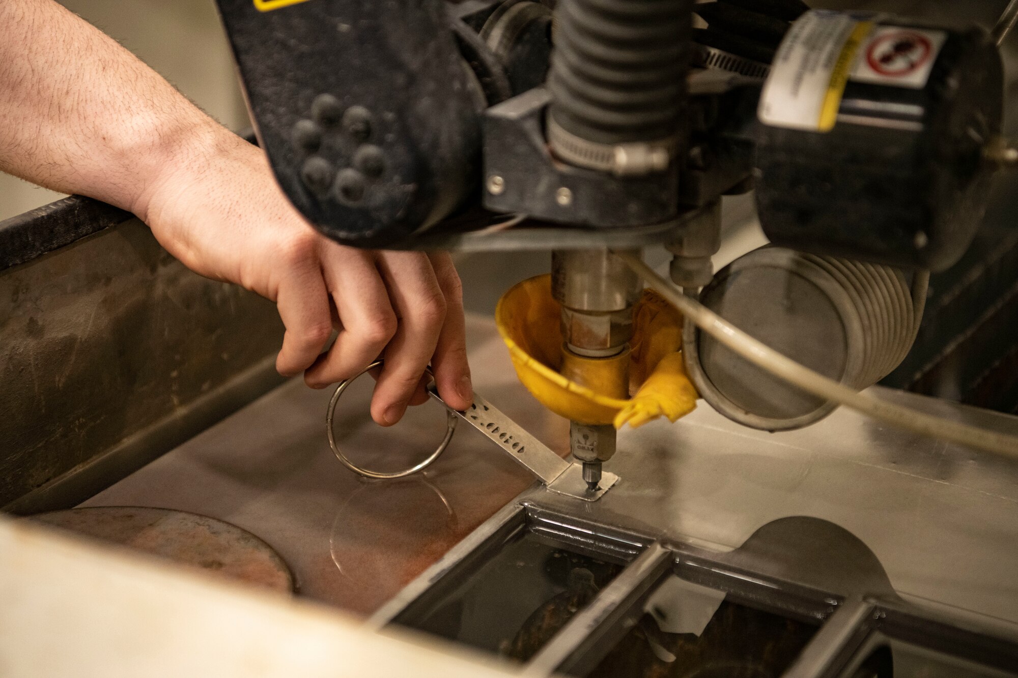Airman Samuel Arnold, 8th Maintenance Squadron aircraft metals technology apprentice, sets the cut height for a machine at Kunsan Air Base, Republic of Korea, Aug. 26, 2022. Metals technology Airmen attend a 90-day technical school where they learn the basics of hand-tool usage, welding and machining. (U.S. Air Force photo by Staff Sgt. Sadie Colbert)
