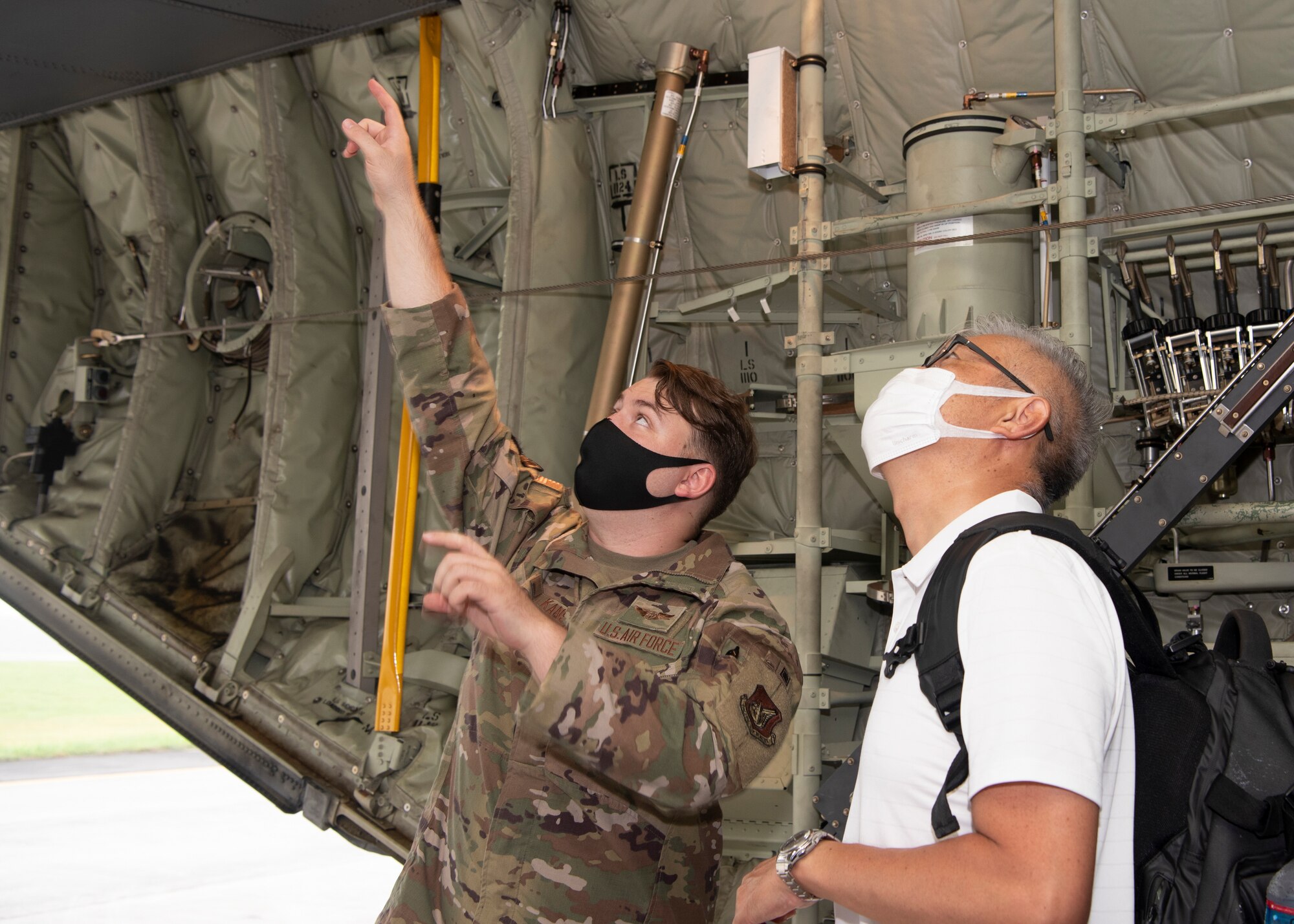 Airman 1st Class Spencer Kans, 36th Airlift Squadron loadmaster, answers a question from a local aviation enthusiast during a tour at Yokota Air Base, Japan, Aug. 31, 2022.