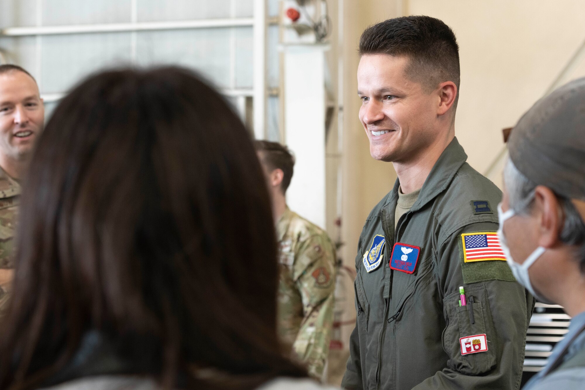 Capt. Matthew Helm, 459th Airlift Squadron UH-1N pilot, speaks with local aviation enthusiasts during a tour at Yokota Air Base, Japan, Aug. 31, 2022.