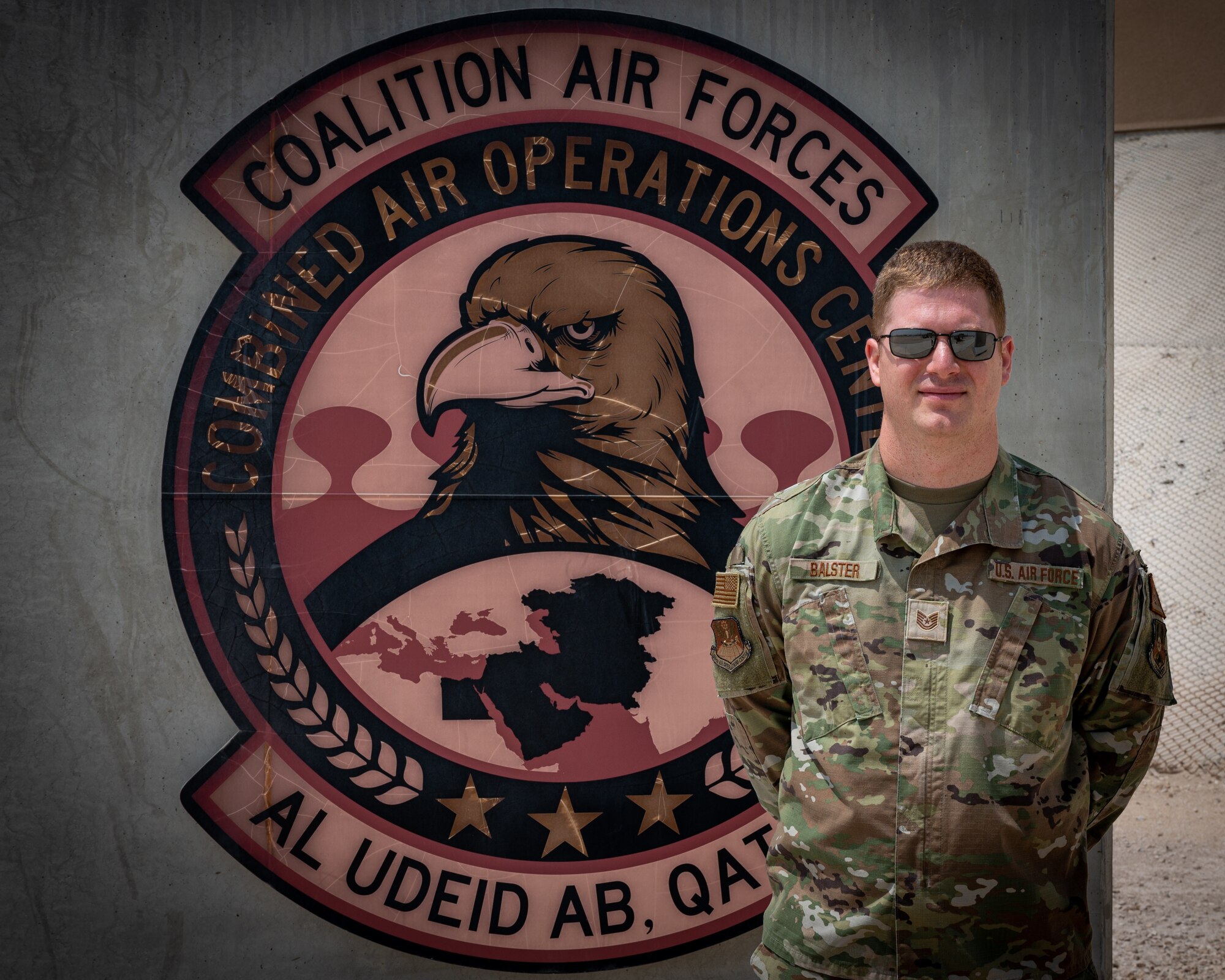 U.S. Air Force Tech. Sgt. Bradley Balster, 609th AOC target development cell production supervisor, poses for a photo at Al Udeid Air Base. Balster implemented an innovate process that significantly decreases the amount of time analysts need to create presentations by writing a programming script that verifies the information is properly formatted. (U.S. Air Force photo by Senior Airman Dominic Tyler)