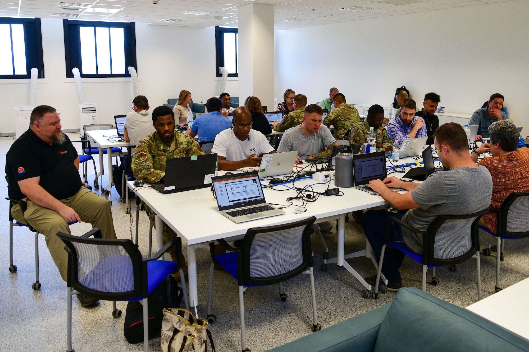 U.S. Air Force members and civilians work on individual automations during a Robotics Process Automation (RPA) Roadshow Course at Aviano Air Base, Italy, Aug. 25, 2022. Automations streamline work processes, shorten timelines and minimize human errors. (U.S. Air Force by Senior Airman Brooke Moeder)