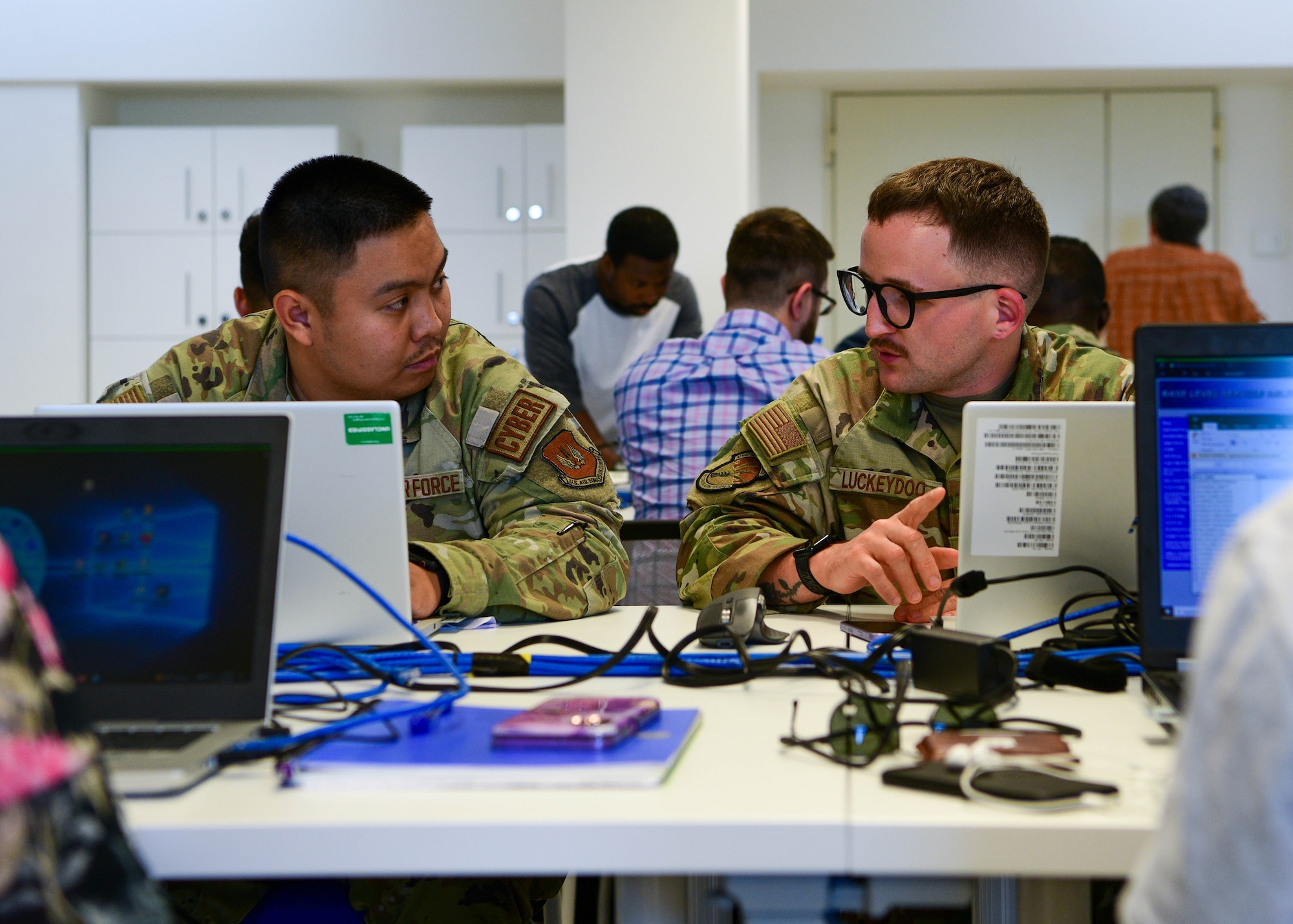 Airman 1st Class Norman Malabey, 31st Communications Squadron knowledge management technician, and U.S. Air Force Staff Sgt. Christopher Luckeydoo, 31st CS NCOIC of information communications systems, work on automations during a Robotics Process Automation (RPA) Roadshow Course at Aviano Air Base, Italy, Aug. 25, 2022. Wyvern Spark hosted the Robotics Process Automation (RPA) Roadshow Course Aug. 22-26 at Aviano AB, which was also the first time the course was conducted in U.S. Air Forces in Europe and Air Forces Africa. (U.S. Air Force by Senior Airman Brooke Moeder)