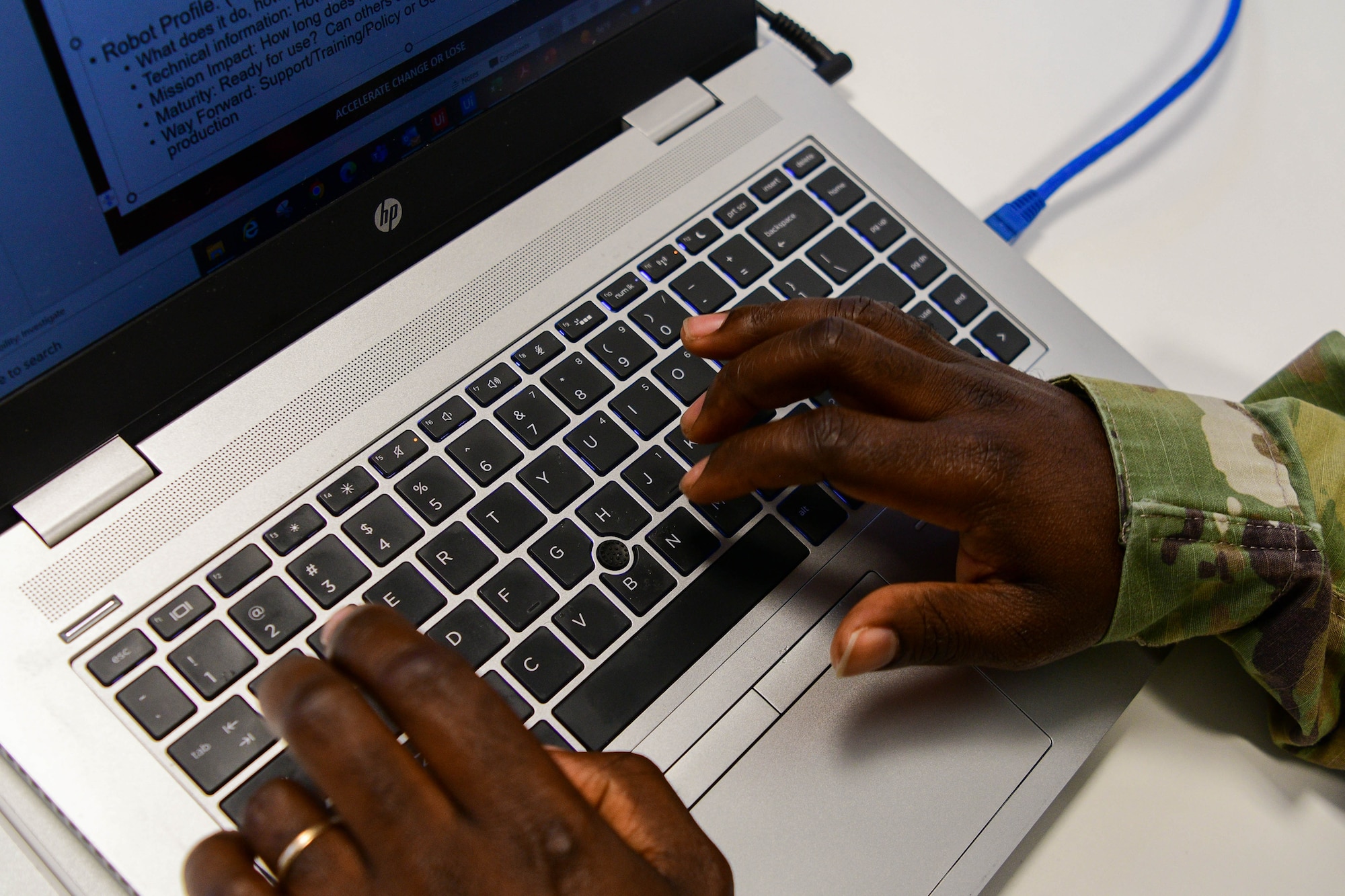 Tech. Sgt. Godwin Opoku, 31st Logistics Readiness Squadron NCOIC of personal property, types on a computer during a Robotics Process Automation (RPA) Roadshow Course at Aviano Air Base, Italy, Aug. 25, 2022. Opoku built an HHG Shipment Bot automation which will be able to create shipments for all the base population during moves, instead of creating a portion of shipments for first time movers, separatees and retirees. (U.S. Air Force by Senior Airman Brooke Moeder)