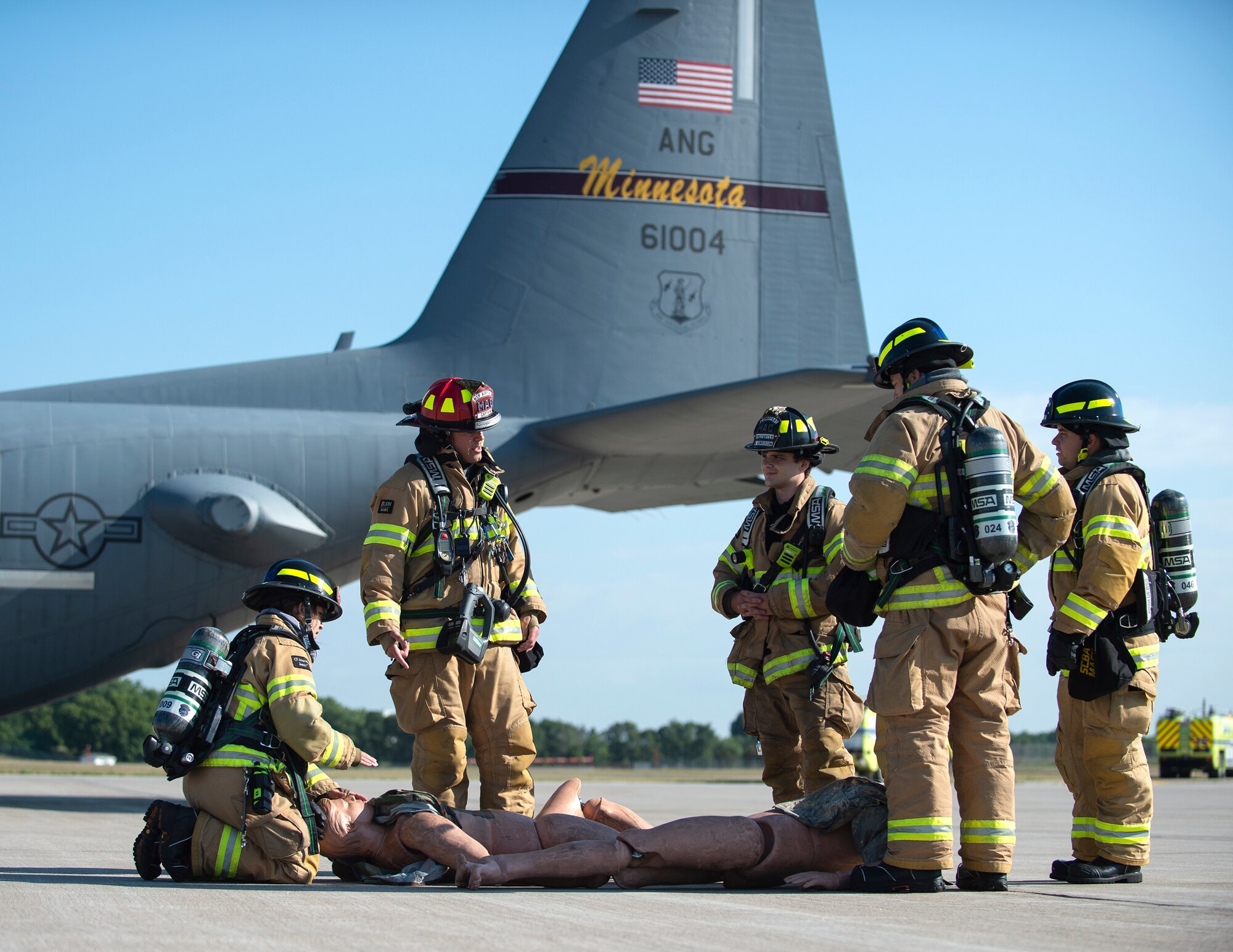 Firefighters from the Minneapolis-St. Paul Airport pulled a simulated victim from a simulated C-130 Hercules crash in St. Paul, Minn., Aug. 10, 2022.