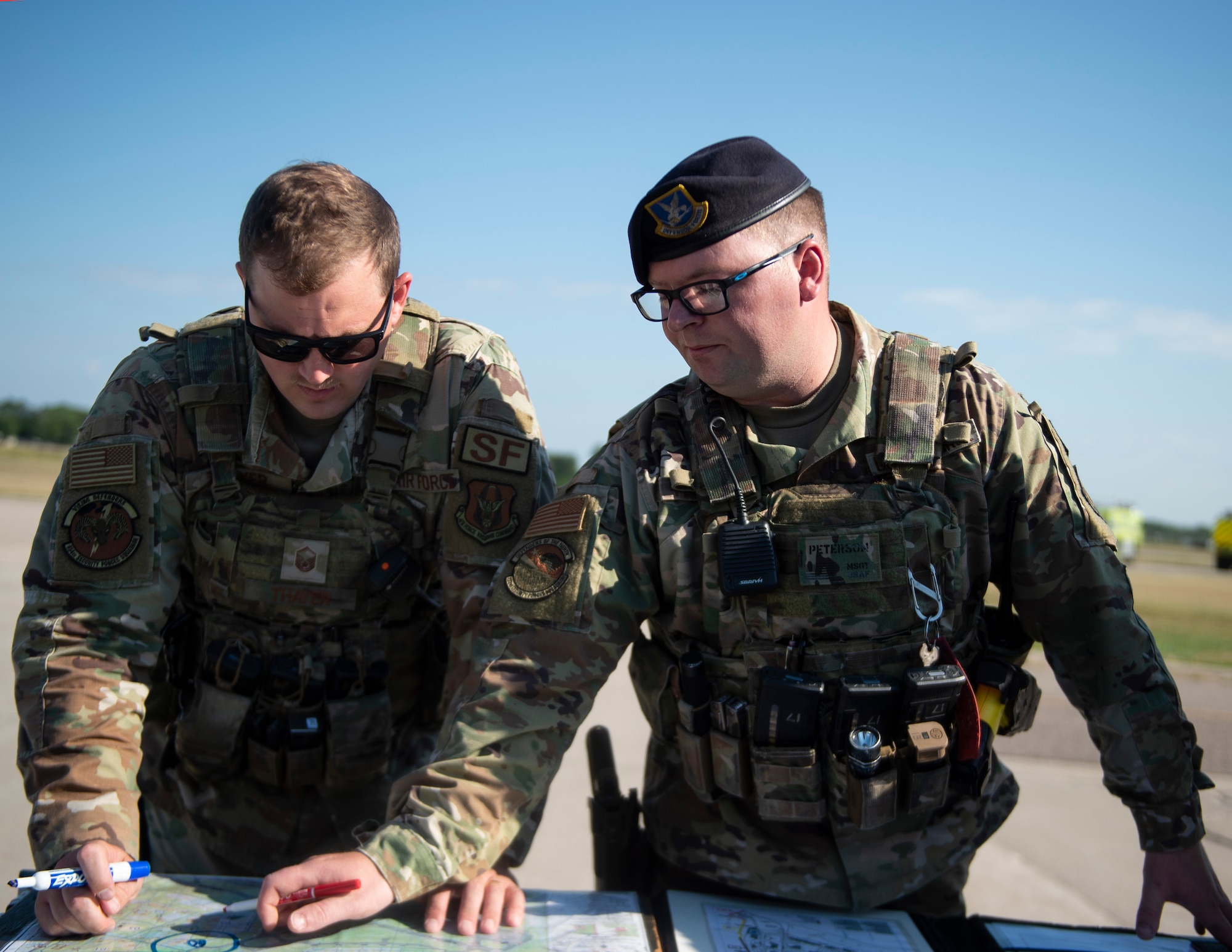 U.S. Air Force Airmen from the 133rd and 934th Security Forces Squadrons fill in the information on a map during a Massive Accident Response Exercise (MARE) in St. Paul, Minn., Aug. 10, 2022.