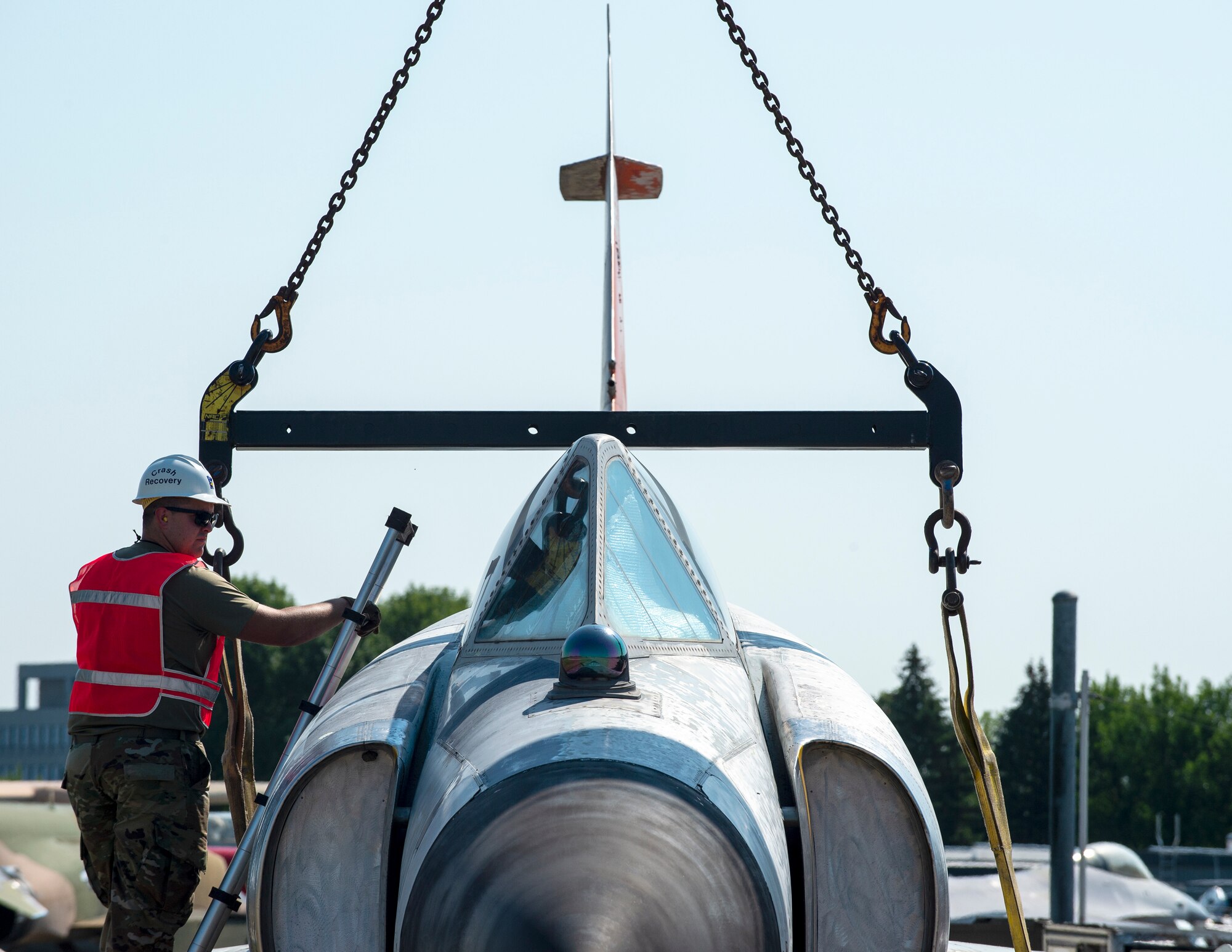 U.S. Air Force Airmen from 133rd and 934th Maintenance Groups along with Twin Cities Towing prepare to lift a Convair F-102A in St. Paul, Minn., Aug. 10, 2022.