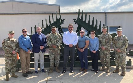 Three executive leaders from U.S. Army Sustainment Command’s Acquisition Integration and Management Center and its Logistics Civil Augmentation Program visited the Coleman Army Prepositioned Stocks-2 worksite in Mannheim, Sept. 1. Deputy to the Executive Director, Acquisition Integration and Management Center James Coffman; Chief of Contract Cost Management Division Angela Williams and LOGCAP Executive Officer John Dengler received an APS-2 briefing, windshield tour of the APS-2 site and walkthrough of a couple of the facilities. Pictured here, the ASC executive leaders pose for a photo with leadership from Army Field Support Battalion-Mannheim and the 405th Army Field Support Brigade. (Courtesy photo)