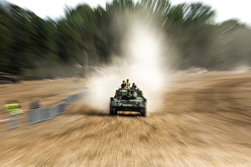 People ride in a tank.