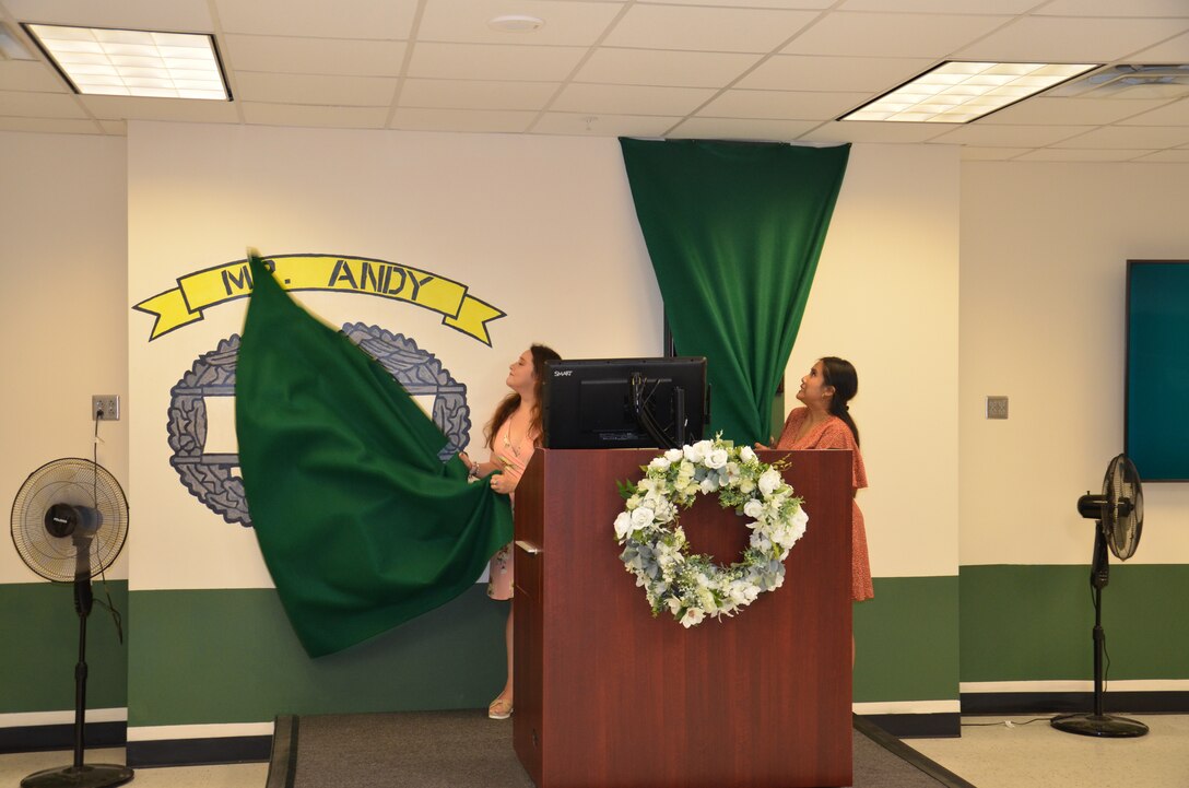 A classroom in the Medical Education and Training Campus Navy Hospital Corpsman Basic program was dedicated in honor of Mr. Andy Sivilaythong, a long-time instructor in the program who passed away in early 2022. Mr. Sivilaythong's fiancée, Sondra Walters, and sister, Marry Sivilaythong, helped unveil the memorial wall dedicated to him.