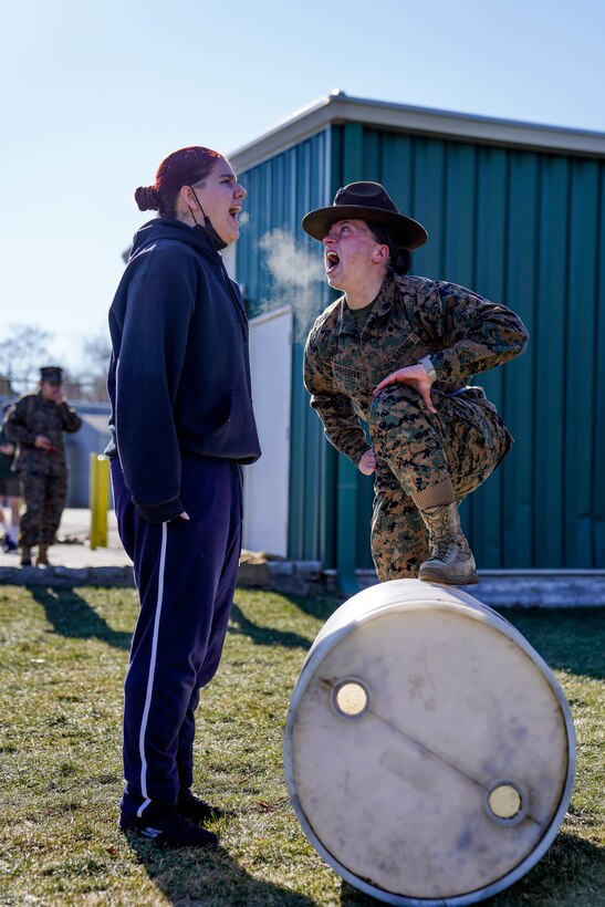 U.S. Marine Corps Staff Sgt. Lily Banhegyesi, a drill master with Marine Corps Recruit Depot Parris Island, South Carolina, corrects a future Marine during a pool function at Recruiting Station New York in Garden City, New York, Jan. 22, 2022. Banhegyesi, a native of Syosset, Long Island, New York, attended the event to assist future Marines in mental and physical preparation for Marine Corps Recruit Training. (U.S. Marine Corps photo by Sgt. Tia Carr)