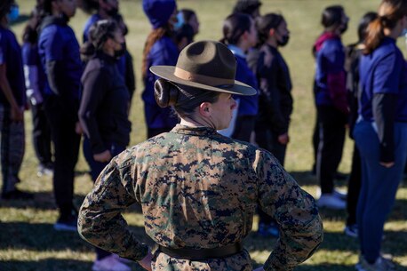 U.S. Marine Corps Staff Sgt. Lily Banhegyesi, a drill master with Marine Corps Recruit Depot Parris Island, South Carolina, oversees future Marine in the conduct of close order drill movements during a pool function at Recruiting Station New York in Garden City, New York, Jan. 22, 2022. Banhegyesi, a native of Syosset, Long Island, New York, attended the event to assist future Marines in mental and physical preparation for Marine Corps Recruit Training. (U.S. Marine Corps photo by Sgt. Tia Carr)