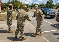 Joint Task Force Civil Support commanding general, U.S. Army Maj. Gen. Jeffrey P. Van, left, greets Commander of North American Aerospace Defense Command and U.S. Northern Command, U.S. Air Force Gen. Glen D. VanHerck, during a visit to JTF-CS headquarters on Fort Eustis, Virginia, Aug. 30, 2022.
