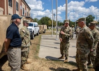 U.S. Army Maj. Darren Hamby, center right, the Incident Support Team 1 officer in charge assigned to Joint Task Force Civil Support describes the team’s ability to rapidly deploy in response to a catastrophic manmade or natural disaster to Commander, North American Aerospace Defense Command and U.S. Northern Command U.S. Air Force Gen. Glen D. VanHerck, right, during a visit to JTF-CS headquarters on Fort Eustis, Virginia, Aug. 30, 2022.
