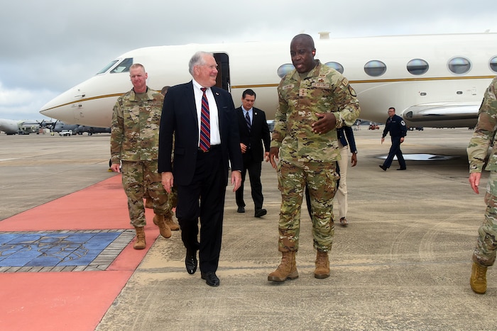 Photo shows group of people walking away from small aircraft