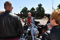 Man speaking to a group of motorcycle riders
