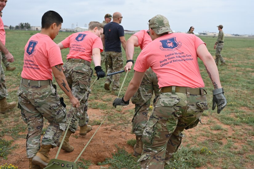 The Air Force District of Washington team works together during the Commando Challenge to pull a mock wounded solider on a stretcher across the finish line at Cannon Air Force Base, N.M., Aug. 18, 2022. The Commando Challenge is a competition that caps off the Medic Rodeo by having teams race while completing exercises and providing care to their patients. The Medic Rodeo, hosted by the 27th Special Operations Wing, creates a ready medical force by testing the knowledge and skills of medics across the Air Force. (U.S. Air Force photo by 2nd Lt. Brandon DeBlanc)