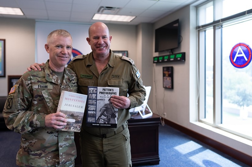 U.S. Army Central's commanding general, Lt. Gen. Patrick Frank, conducts a gift exchange with Maj. Gen. Hidai Zilberman, Israeli Defense and Armed Forces Attaché to the U.S., at USARCENT Headquarters August 31, 2022
