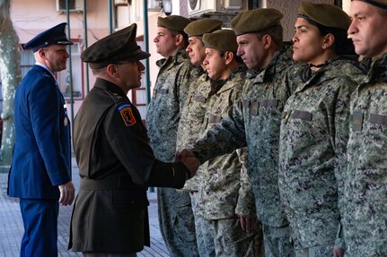 U.S. Army Maj. Gen. Francis Evon, left foreground, the Connecticut adjutant general, shakes hands with a Uruguayan Army soldier during a visit to the National Peace Operations Training School of Uruguay, Montevideo, Uruguay, Aug. 10, 2022. The school is where Uruguayan military and police forces train to prepare to deploy in support of U.N. peacekeeping operations.