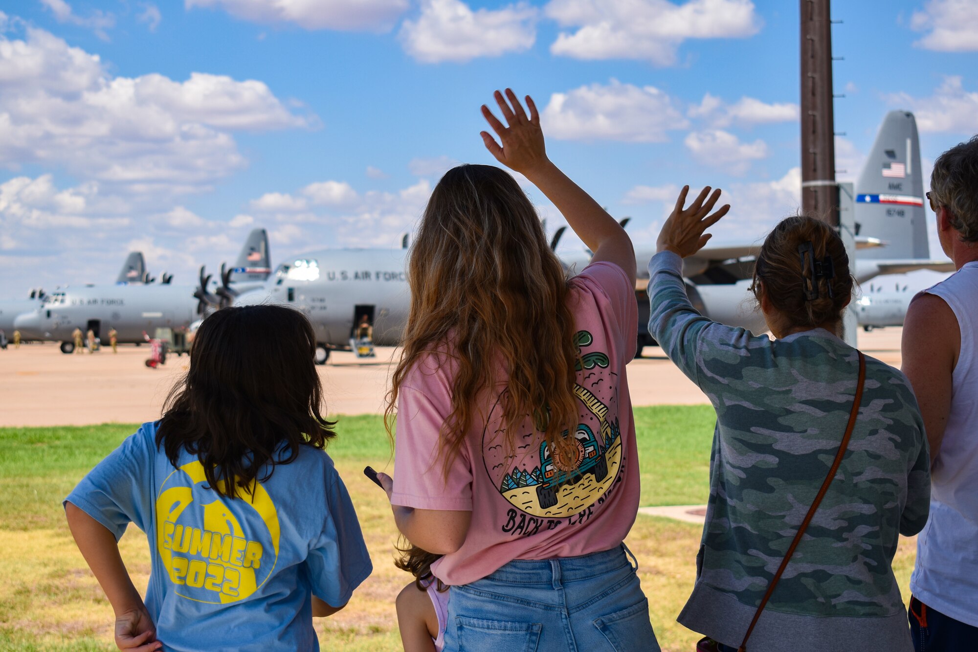 The deployers gathered to say goodbye to family members before their departure. Spouses, children and parents expressed farewell with signs, snacks, hugs and kisses as the deployers completed final out processing and boarded aircraft. The C-130 unit’s deployment to Kuwait in support of U.S. Central Command taskings marks the first implementation of the Air Force Generation model in Air Mobility Command. (U.S. Air Force photo by 1st Lt. Kaitlin Cashin)