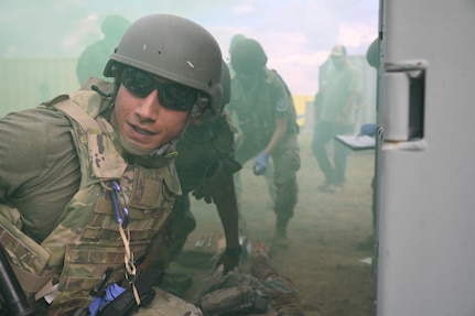 Tech. Sgt. Robert Cassidy, from Tyndall Air Force Base, Fla. prepares to move a mock wounded soldier during a simulated combat zone scenario at Melrose Air Force Range, N.M., Aug. 17, 2022. The Medic Rodeo, hosted by the 27th Special Operations Wing, creates a ready medical force by testing the knowledge and skills of medics across the Air Force. (U.S. Air Force photo by 2nd Lt. Brandon DeBlanc)