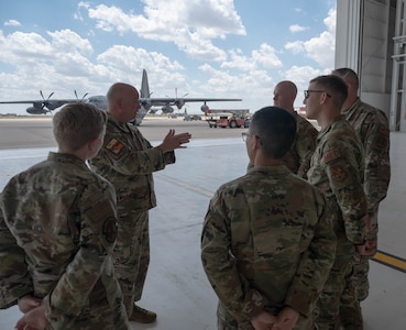 The Air Force District of Washington team speaks with Brig. Gen. Thomas Harrell, Air Force Medical Readiness Agency commander, after the 2022 Medic Rodeo opening ceremony at Cannon Air Force Base, N.M., Aug. 15, 2022. The Medic Rodeo, hosted by the 27th Special Operations Wing, creates a ready medical force by testing the knowledge and skills of medics across the Air Force. (U.S. Air Force photo by 2nd Lt. Brandon DeBlanc)