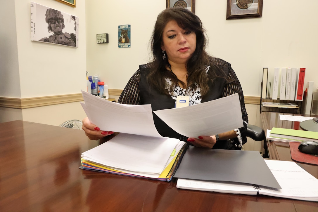 Rosario Swafford, U.S. Army Corps of Engineers Mobile District’s personnel security specialist, reviews security memorandums at her office Aug. 31, 2022, in Mobile, Alabama. Swafford said she enjoys working with people, especially for her USACE team. (U.S. Army photo by Chuck Walker)