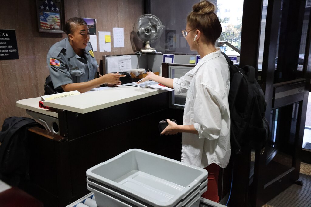 Kimberly Taylor, a Mobile District protection security officer, verifies a common access card at the main entrance to the Mobile District Office on Aug. 31, 2022, in Mobile, Alabama. Physical Security of the District Office is one of the many duties that the Security Office is in charge of to ensure a safe work environment. (U.S. Army photo by Chuck Walker)