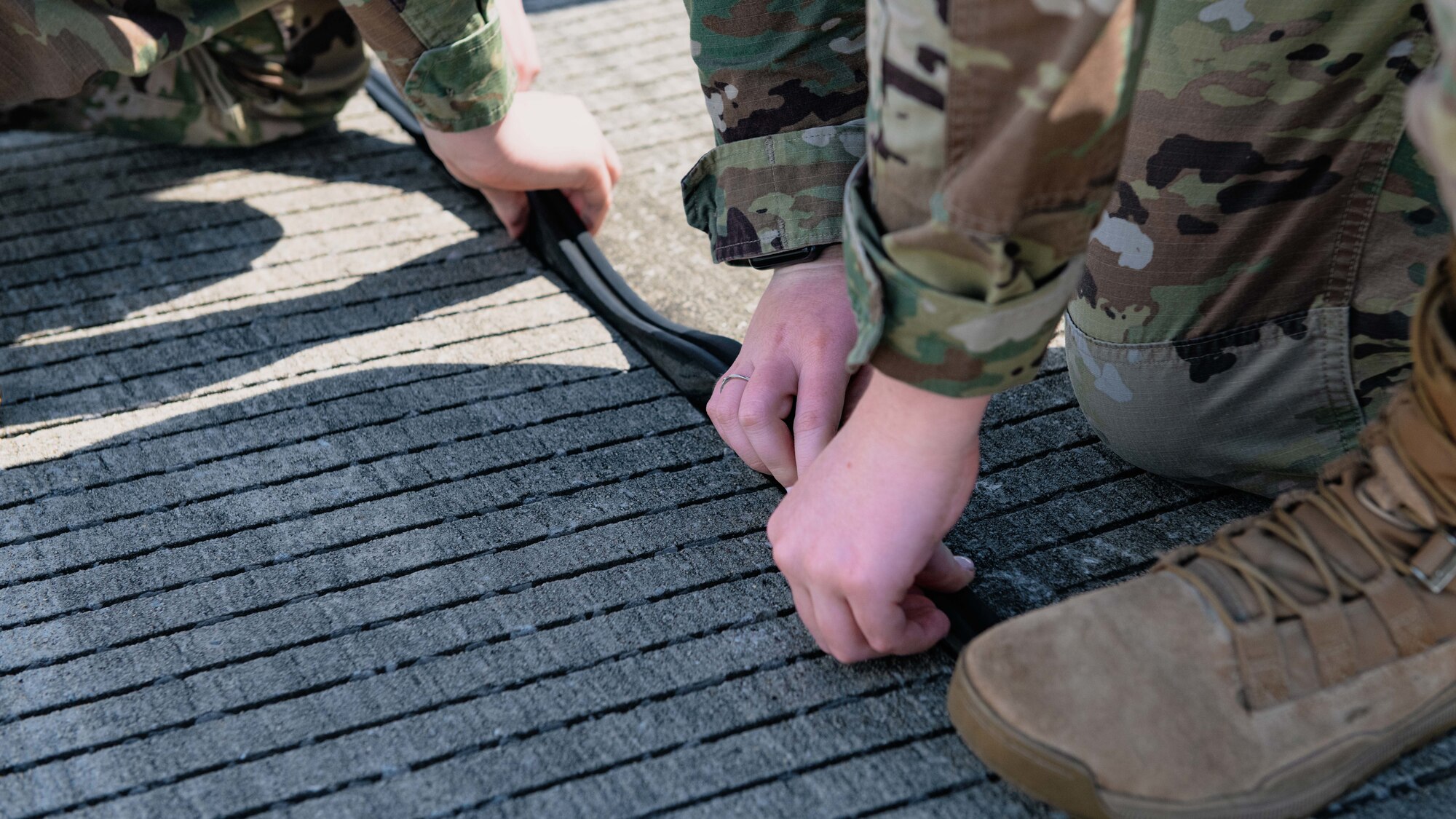 Airmen remove debris from the flightline.