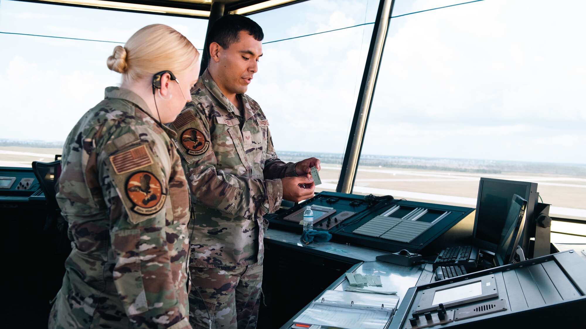 Airmen inspect a document.