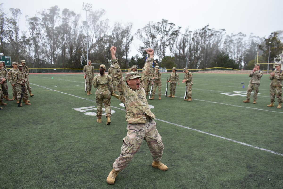 U.S. Air Force Lt. Col Juan J. Araoz, 314th Training Squadron commander, celebrates after the 314th TRS drill team wins the 2022 Drill Down competition at the Price Fitness Center, Presidio of Monterey, Calif., Aug. 19, 2022. Next quarter, teams from the 517th Training Group, 17th TRG, and Goodfellow joint service units will compete against one another.  (Courtesy photo 517th TRG)