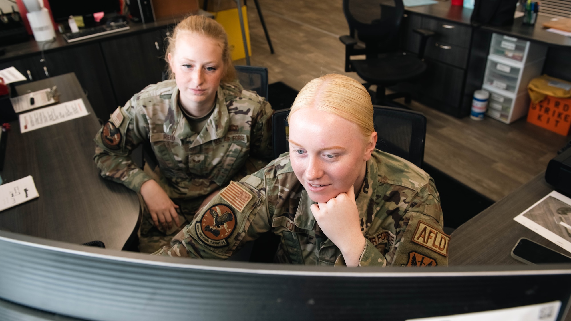 Airmen use computer.