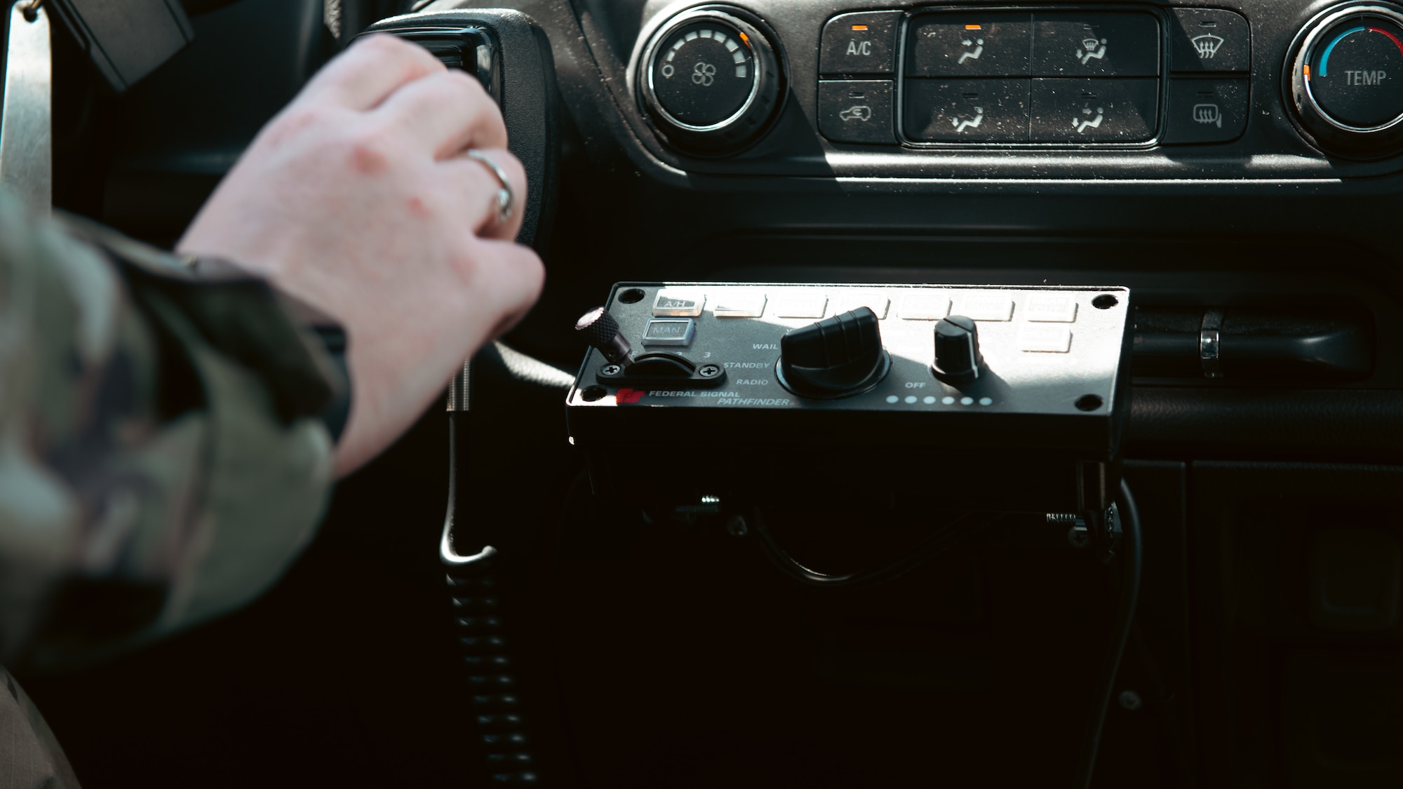 Airman adjusts a radio.
