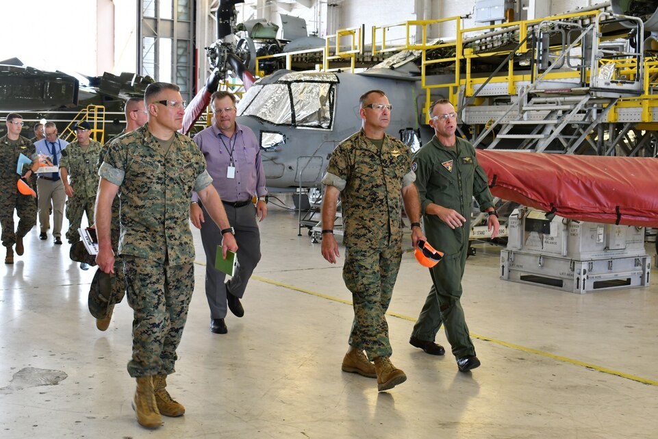 Fleet Readiness Center East (FRCE) Executive Officer Lt. Col. Jason Raper (right) discusses MV-22 overhaul operations with Maj. Gen. Scott F. Benedict, commanding general of 2nd Marine Aircraft Wing (MAW), during an Aug. 30 tour of the depot by 2nd MAW leadership. The tour focused on the MV-22 Osprey, F-35 Lightning II and future plans for F-35 maintenance and capabilities at FRCE.