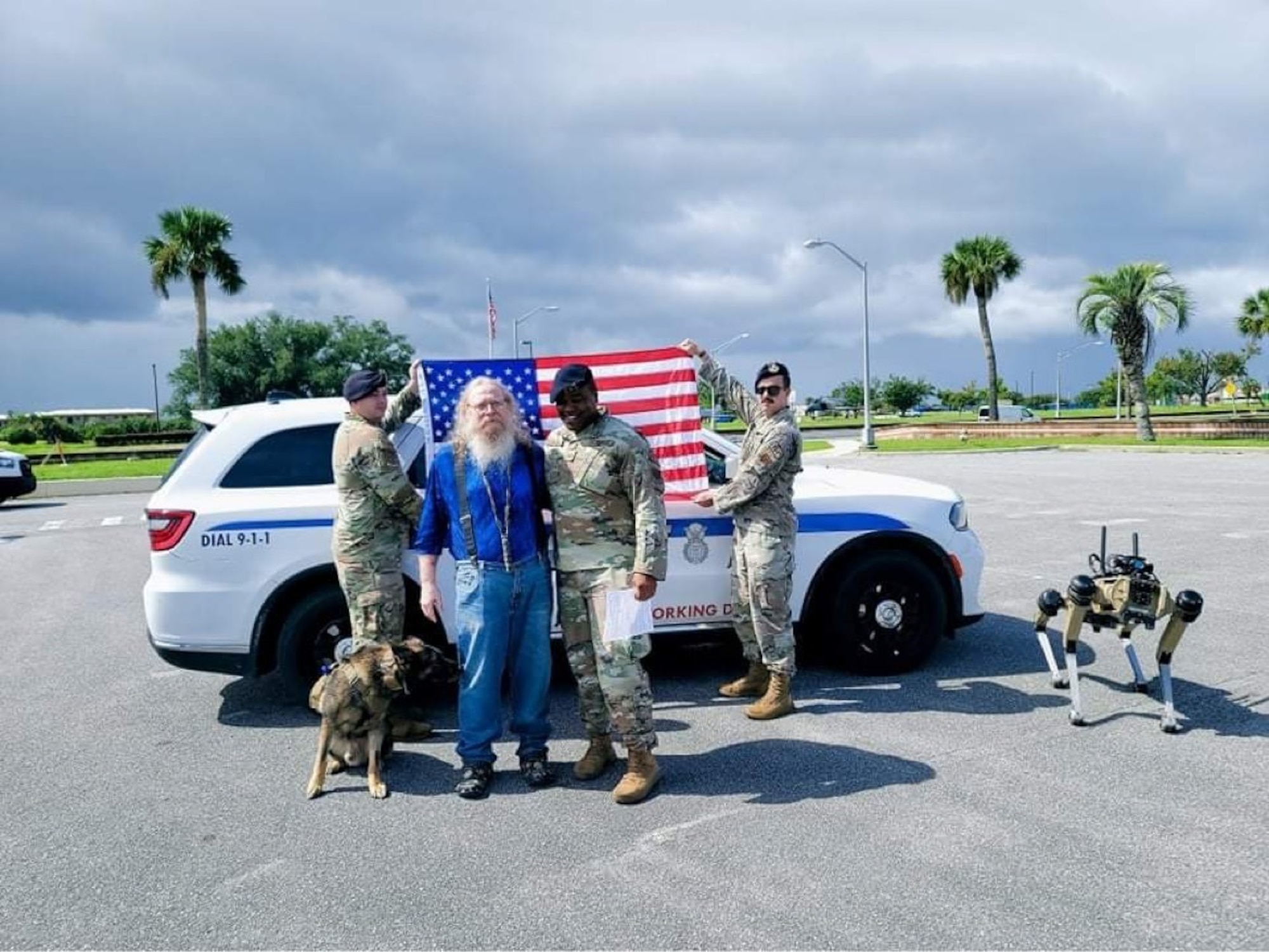 Retired U.S. Air Force Lt. Col. Daniel Coshatt, center left, and Tech. Sgt. Billy Lofton, 325th Security Forces Squadron noncommissioned officer in charge of plans, pose for a photo following a re-enlistment ceremony at Tyndall Air Force Base, Florida, Aug. 12, 2022.