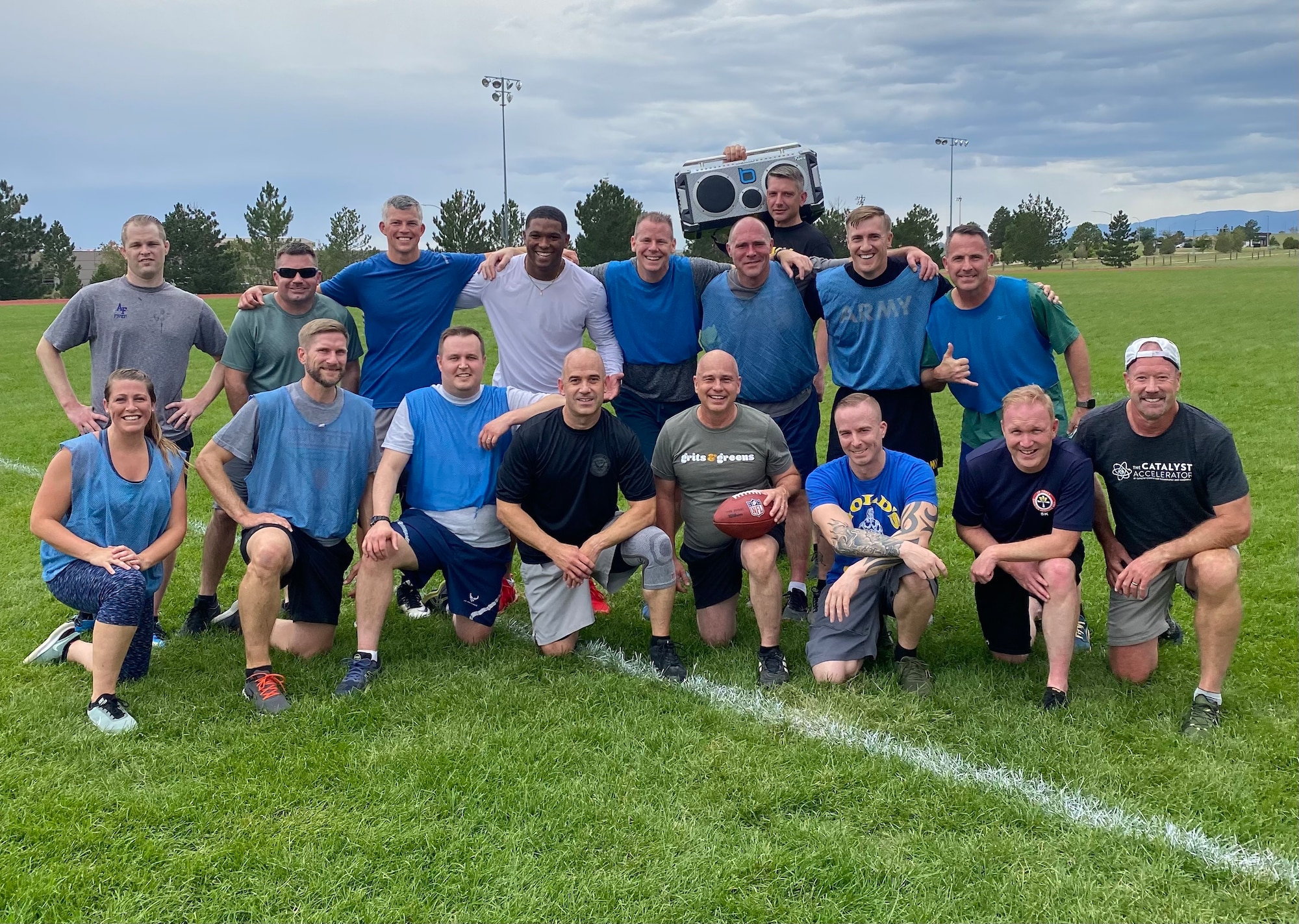 Group of people in athletic clothing pose for a group photo