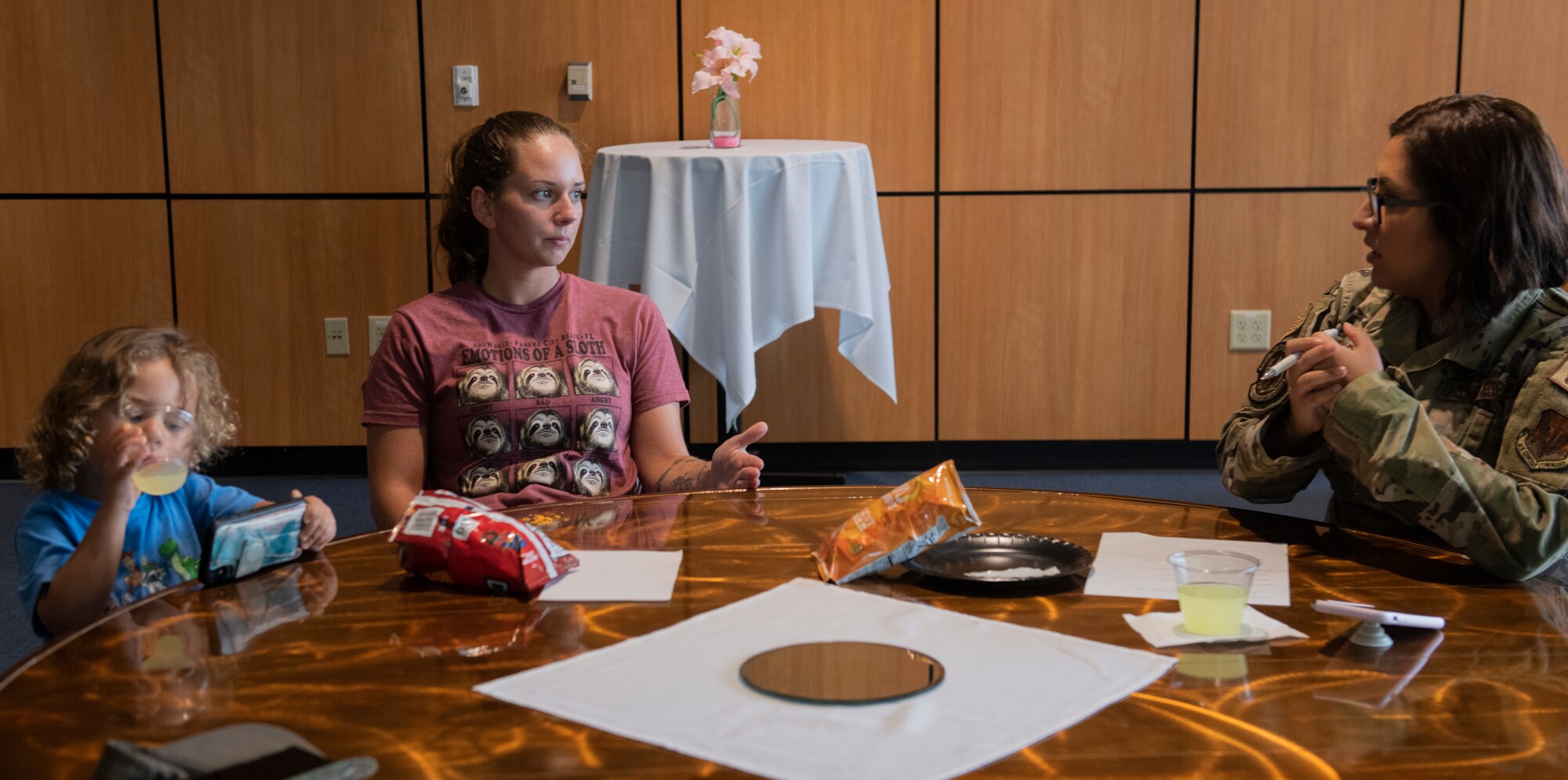 U.S. Air Force Tech. Sgt. Victoria Negrete, 325th Force Support Squadron mail manager, right, speaks to a new member of the Single Parents of Tyndall group at Tyndall Air Force Base, Florida, Aug. 24, 2022.