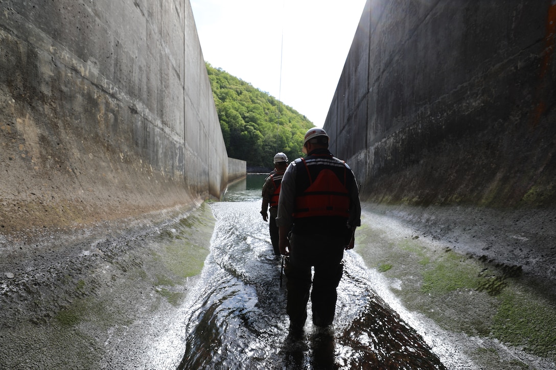 Anthony Lockridge, supervisory facility operations specialist and dam operator for USACE Norfolk District, exits the Gathright Dam outlet tunnel during a semi-annual dam inspection. (U.S. Army photo by Breeana Harris)