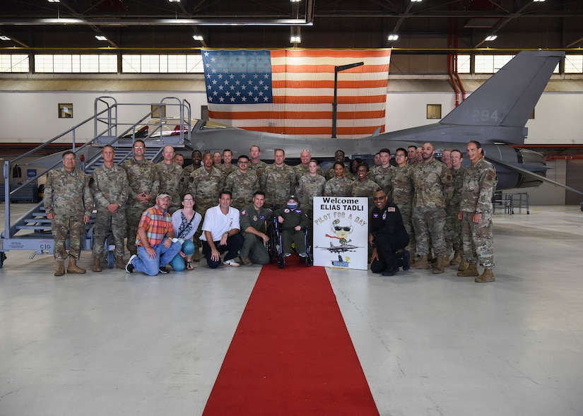 Eight-year-old Elias “Eli” Tadli from Jefferson, Md., poses for a photo with his family and members of the 113th Operations Squadron during a Pilot for a Day visit at Joint Base Andrews, Md., Sept. 1, 2022.